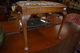 An early 20th Century dressing stool having cabriole legs