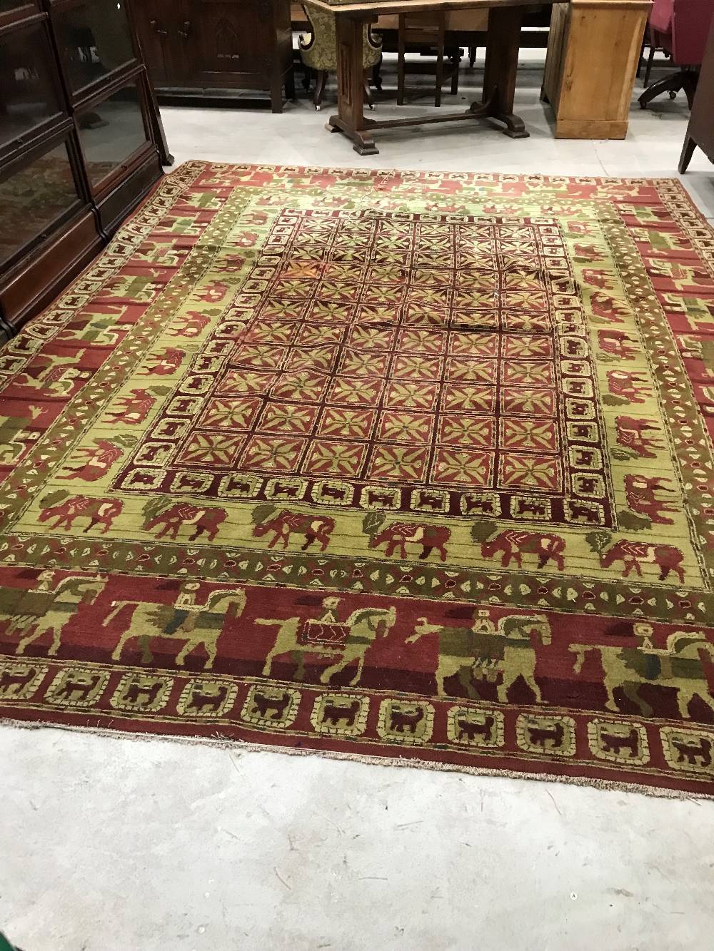 A traditional carpet square having animalistic decoration