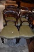A set of four Victorian mahogany balloon back chairs having turned legs and later green dralon