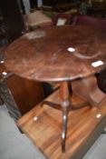 A 19th Century mahogany pedestal table having plum pudding style top of turned column and triple