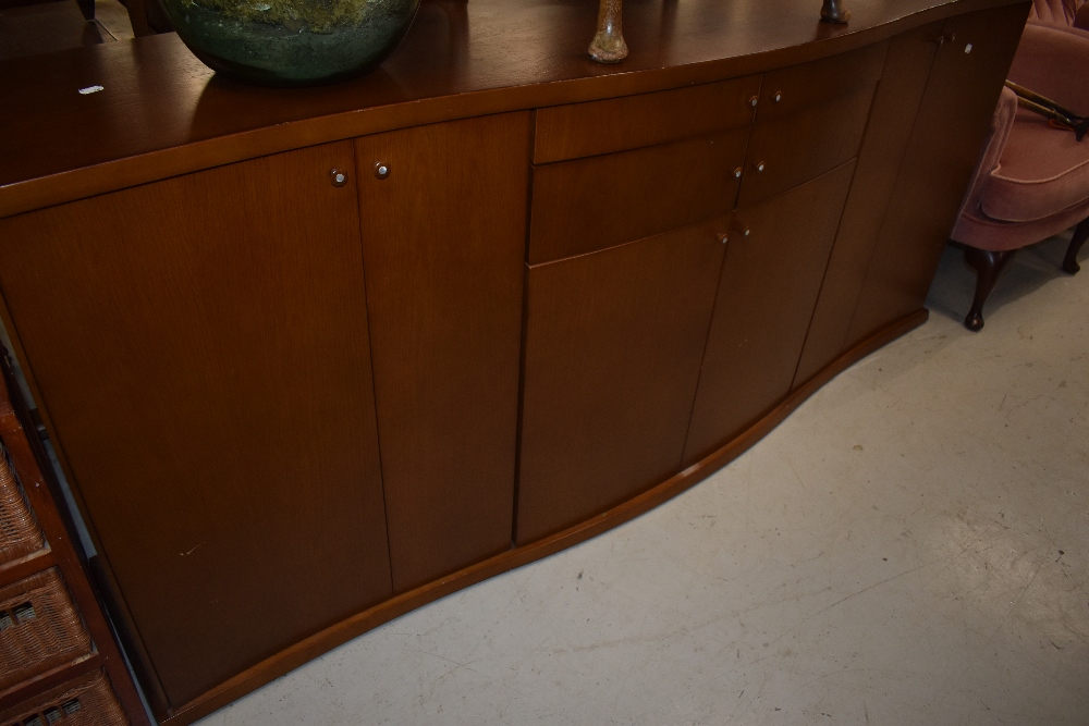 A Scandinavian laminate serpentine front sideboard, labelled Skovby, width 201cm