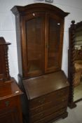 A reproduction oak bureau bookcase in the Georgian style