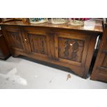 A traditional oak sideboard or dresser base, having carved triple door, width aopprox. 183cm