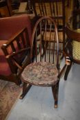 An Ercol or similar hoop and stick back rocking chair, stamped to base BS1060 KF2056