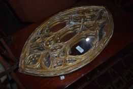 A gilt framed wall mirror in a Victorian gothic style, ideal for Christmas displays