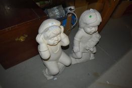 A pair of ornamental plaster figures