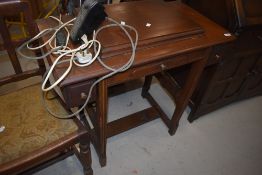 A vintage sewing machine table containing Jones machine