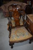 A pair of 19th Century walnut armchairs having vase backs, tapestry seats , cabriole legs and ball