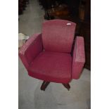 A vintage armchair on swivel base, semi recliner, on metal swivel base in moquette upholstery