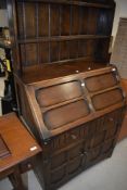 A mid 20th Century oak bureau bookcase in the Priory style