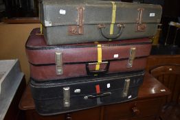 Three vintage suitcases, not leather