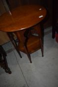 An Arts and Crafts side table having Circular top and hexagonal undertier on file legs, probably