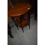 An Arts and Crafts side table having Circular top and hexagonal undertier on file legs, probably