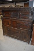 A period oak court cupboard having typical carved decoration , double cupboard to top section and