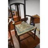 An Edwardian stained frame carver salon chair