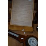 A stripped toilet mirror frame and barometer