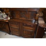 A mid to late 20th Century reproduction court cupboard , width approx. 120cm