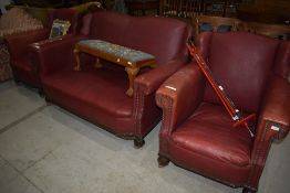 An early 20th Century studded red leather lounge suite