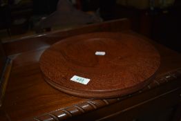 A turned wood plate, possibly from a lazy susan