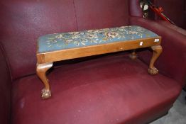 An early 20th Century footstool, having tapestry 'seat' on cabriole legs with ball and claw feet, of