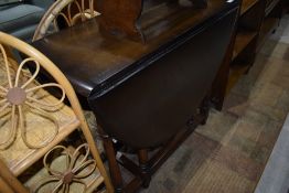 A mid 20th Century dark stained gateleg table, Ercol or similar