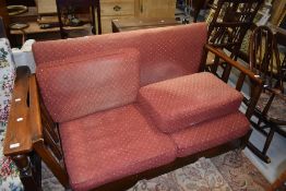 A vintage stained frame drop end settee, on shepherds castors