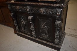A 19th Century Oak sideboard base having three drawers with 'green man' style handles and phoenix