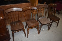 Two pairs of 19th Century oak kitchen chairs, having solid seats, one having spindle and the other