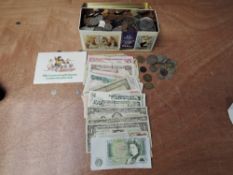 A collection of World Coins and Banknotes in a tin including 26 US Dollar notes, 2 £1 UK notes and