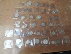 A collection of Commonwealth and World Coins including two Indian Silver Rupees, South African