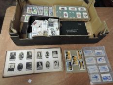 A box of Cigarette Cards in albums and loose including a set of Ogdens Photo Album of Guinea Gold