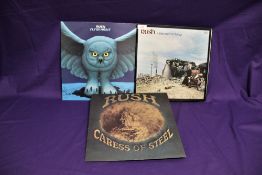 A three album lot of Rush vinyl records