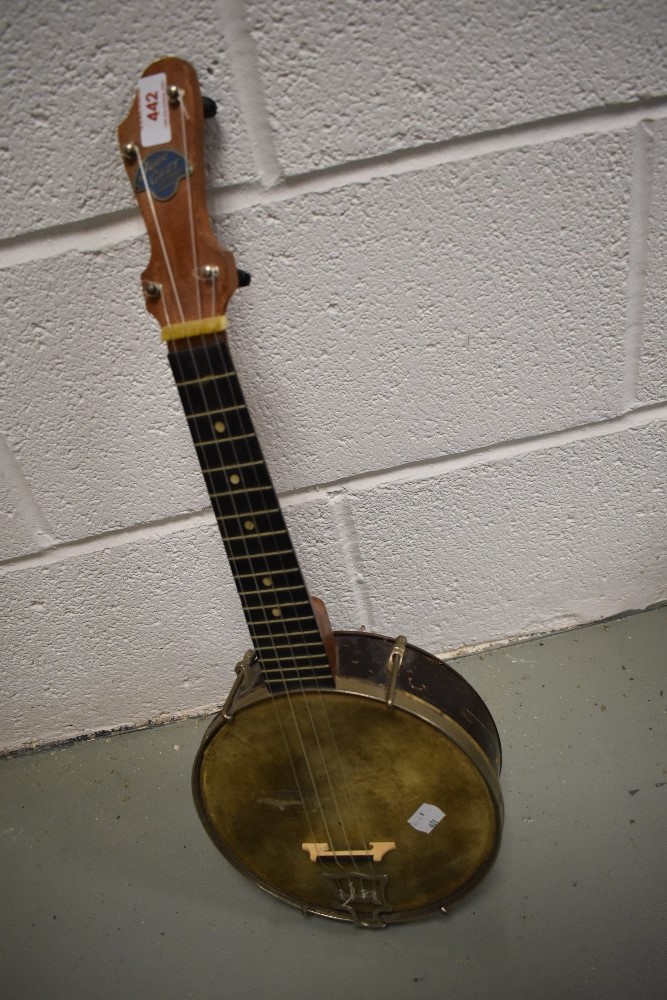 An early 20th Century banjo ukulele, labelled to headstock for John Grey , London, having ply drum