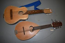 An interesting junior acoustic guitar, possibly scratch built and a traditional teardrop flat back