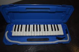 A cased Swan Melodica SW-32 in blue