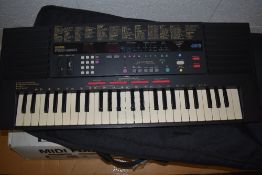A Yamaha PSS-590 keyboard with soft gig bag