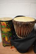 An African Djembe style drum and a similar drum with cartoon type animalistic decoration