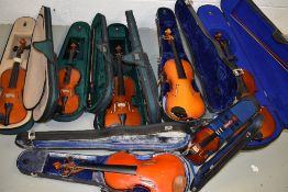 A job lot of seven Chinese violins, various sizes all with cases