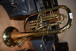 A brass horn, named for B and S, Sonora range, with mouthpiece and vinyl carry bag