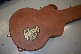 A Gibson guitar case, in tan