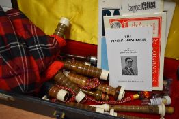 A set of traditional bagpipes in hard case, with some accessories and ephemera etc
