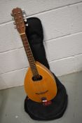 A traditional teardrop flat back mandolin, unmarked, in padded gig bag