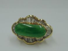 A jadeite cabouchon dress ring, approx 2.8ct within a baguette diamond set ballerina frilled