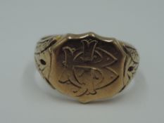 A 9ct rose gold signet ring having monogrammed cartouche and moulded shoulders, size O & 6g