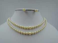 A double row of graduated cultured pearls having a silver box clasp with marcasite decoration,