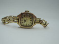 A 9ct gold wrist watch by Accurist having baton numeral dial to square champagne face with 9ct