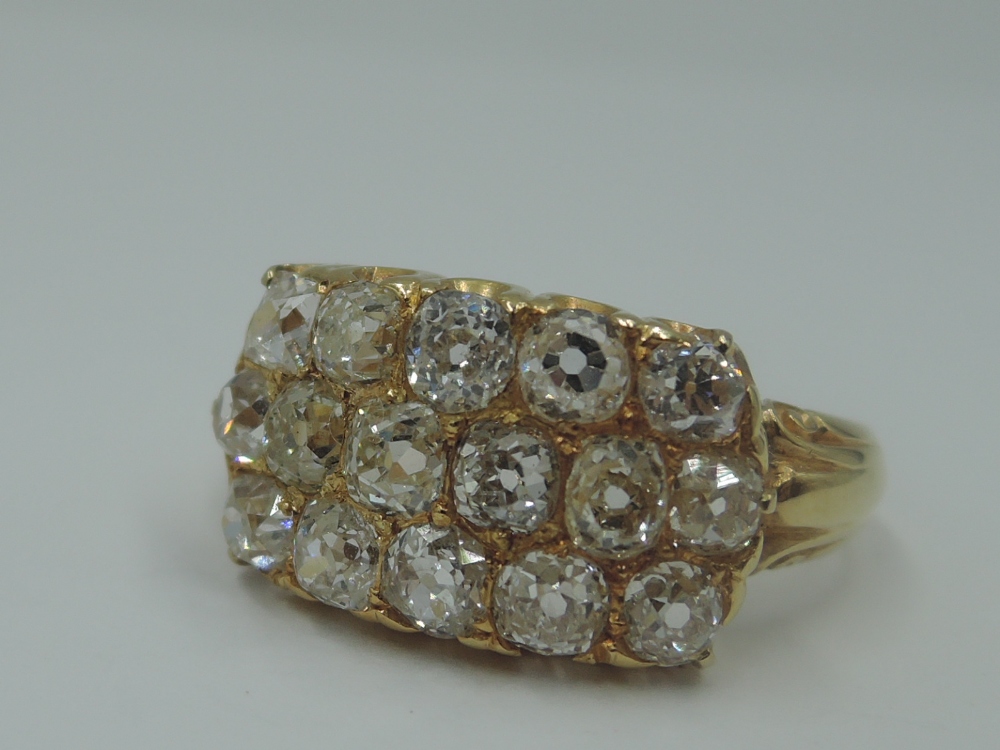 A three row diamond ring having sixteen old cut diamonds, approx 2ct total in a panel setting to