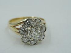 A diamond daisy cluster dress ring, total approx 1.3ct, in a claw and collared basket mount to