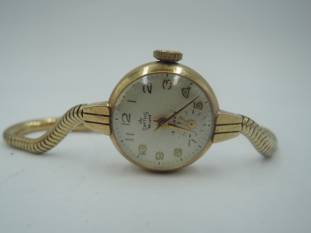 A 9ct gold vintage wrist watch by Smiths having Arabic numeral dial with subsidiary seconds on a 9ct