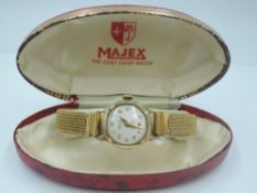 A 9ct gold wrist watch by Majex having Arabic numeral dial with subsidiary seconds to circular
